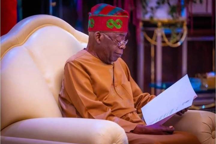 a man in a red hat and glasses reading a book